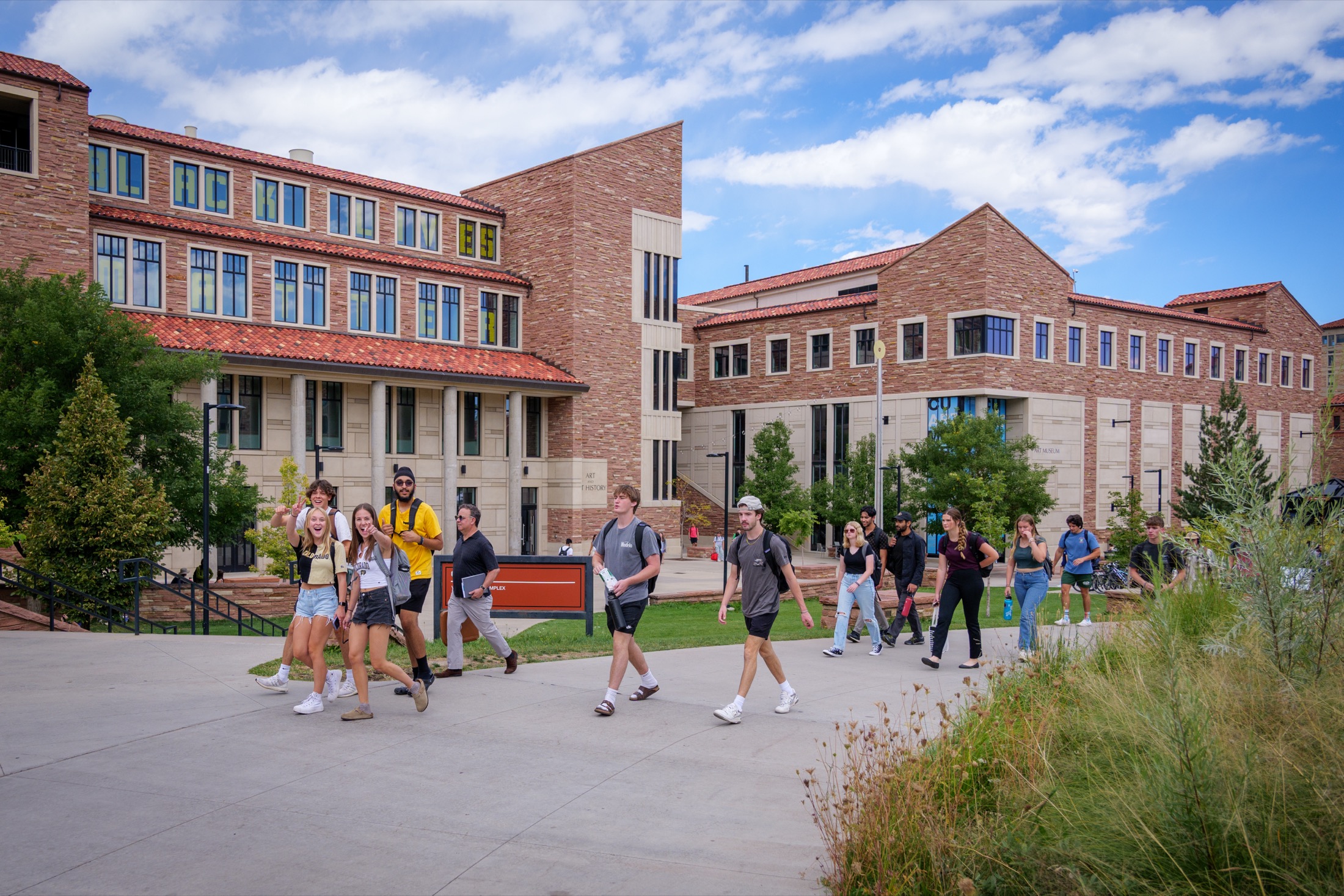 Students walking together across campus between classes at CU Boulder.